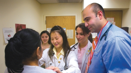 Medical students and physicians examine a patient at Promise Clinic