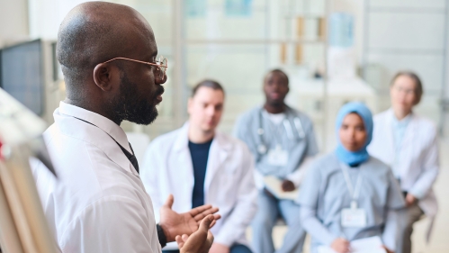 speaker talking to group of doctors during conference