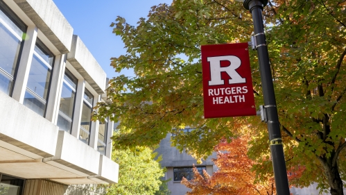 Image of Rutgers Health banner in front of a building