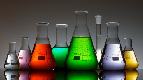 Glass beakers with colorful liquids inside