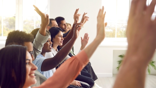 Staff Council banner image of people raising their hands to vote