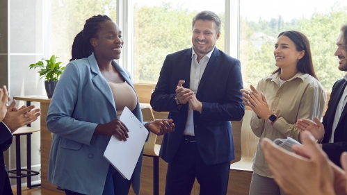 Photo of staff people applauding another staff member