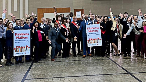 Kindness Day banners held by people