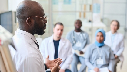 speaker talking to group of doctors during conference