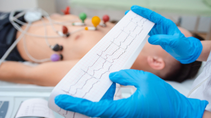 hands holding ECG readout