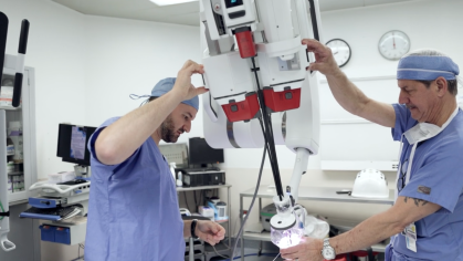 Doctors using a robotic surgery machine