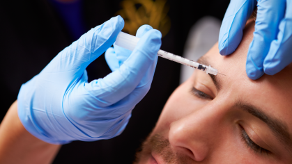A person receiving a botox injection in their forehead