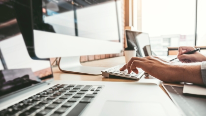 Image of person's hands working on a computer