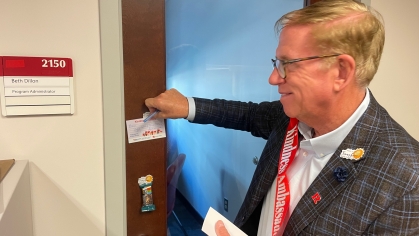 Photo of Keith Lewis knocking on door to spread kindness
