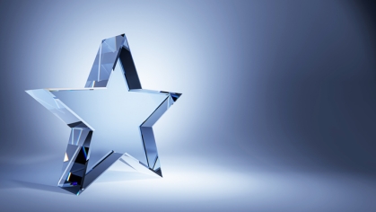Clear star award against blue background