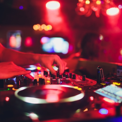 A DJ plays a record in a dark club