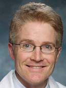 A headshot of Rutgers professor John Collins