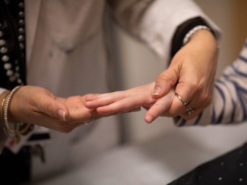 A pediatrician examines a young patient's hand