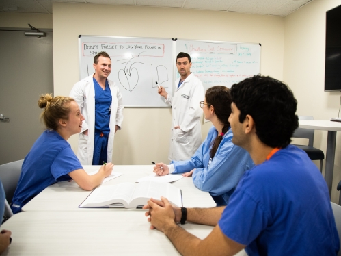Photo of members of the Department of Anesthesiology speaking with one another.