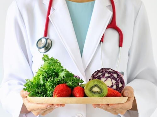 Doctor holding fresh fruit and vegetable, Healthy diet, Nutrition food as a prescription for good health.