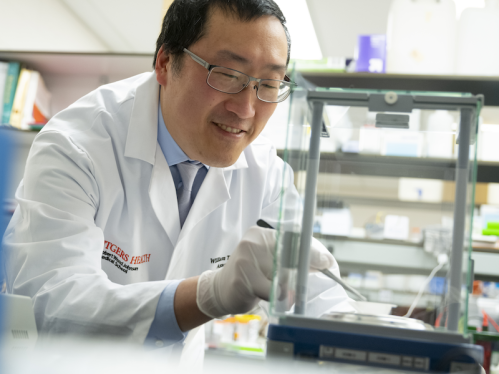 Dr. William Hu conducting research in a lab