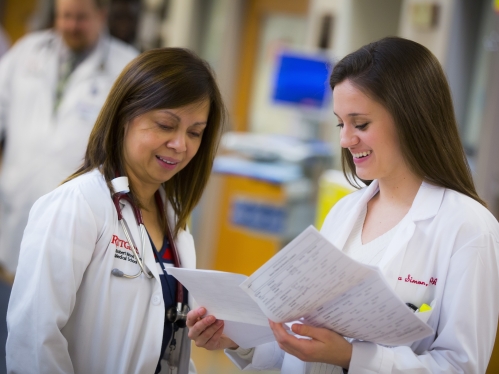 Advanced practice nurse Lalaine Genuino and certified physician assistant Alexa Simon discuss patient notes