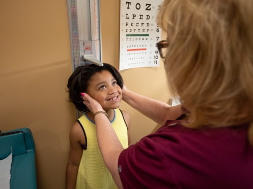 A child being measured for height at the pediatrician's office