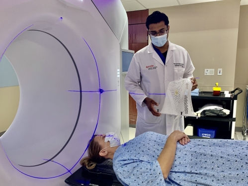 A patient undergoing a scan, hearing instructions from their physician