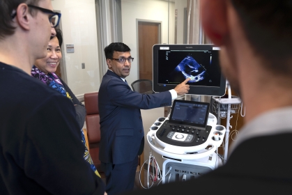 Dr. Sengupta demonstrates for onlookers how he proposes using pocket ultrasound in place of a stethoscope