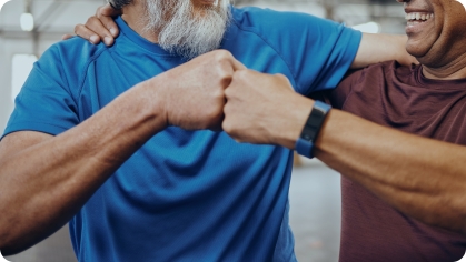 Image of two older men bumping fists