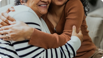 Image of two women hugging and smiling