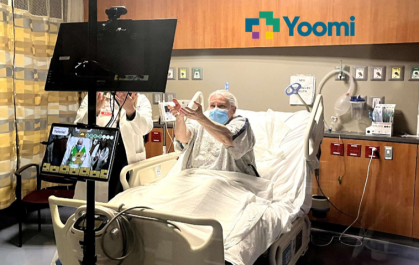 Image of patient in hospital bed with mobilization assistance
