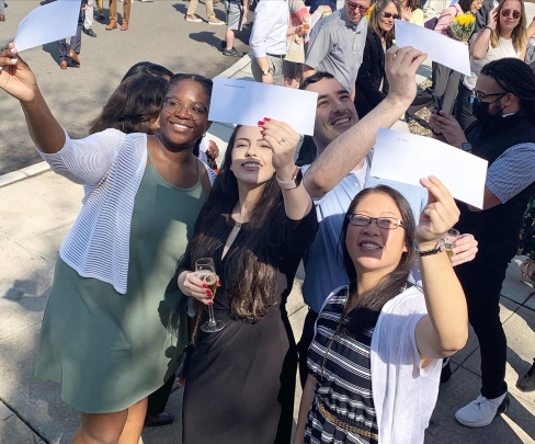 Students celebrate and hold up their match letters on Match Day