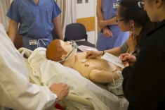 Medical students evaluate a simulation patient in the simulation lab