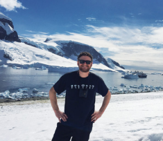 Dr. Reisman poses for a photo in front of water in Antarctica