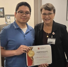 Photo of Dean Murtha presenting Employee of the Month to Arcival Salazar