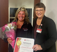 Photo of Dean Murtha presenting Doreen Stillwell with Employee of the Month
