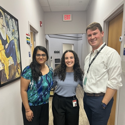 A group of Promise Clinic steering committee members and student doctors in the clinic