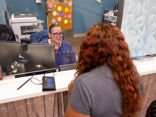 A patient speaks with an employee at the Eric B. Chandler Health Center